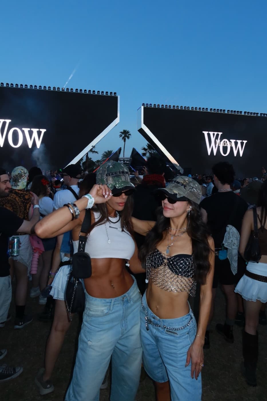 two baddies at a show in front of the screens, one wearing the brooklyn chain